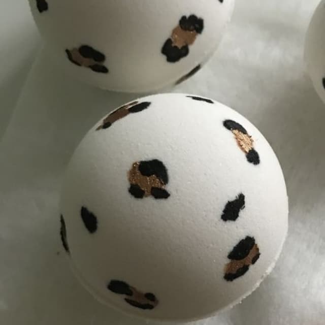 Gold & black leopard art bath bomb with surprise color inside.